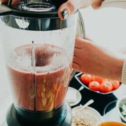 Woman making healthy smoothie in the kitchen, Blender Overheated - What To Do?