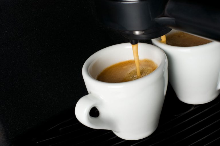 A coffee maker pouring two cups of freshly brewed coffee, How Long Does A Keurig Take To Heat Up?