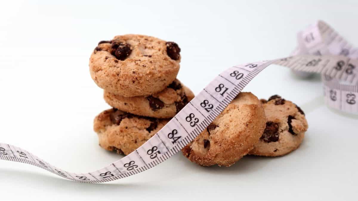A pile of chocolate cookies and a tape measure