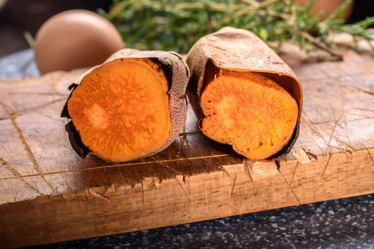 Baked sweet potatoes on a wooden chopping board