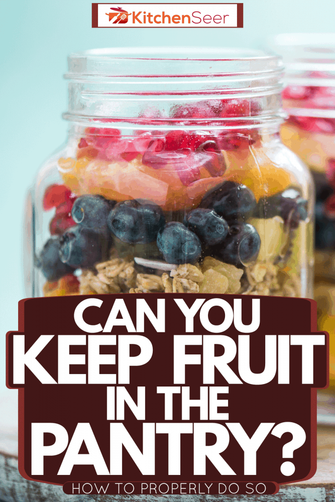 Two jars of assorted fruits on a wooden chopping board, Can You Keep Fruit In The Pantry? [How To Properly Do So]