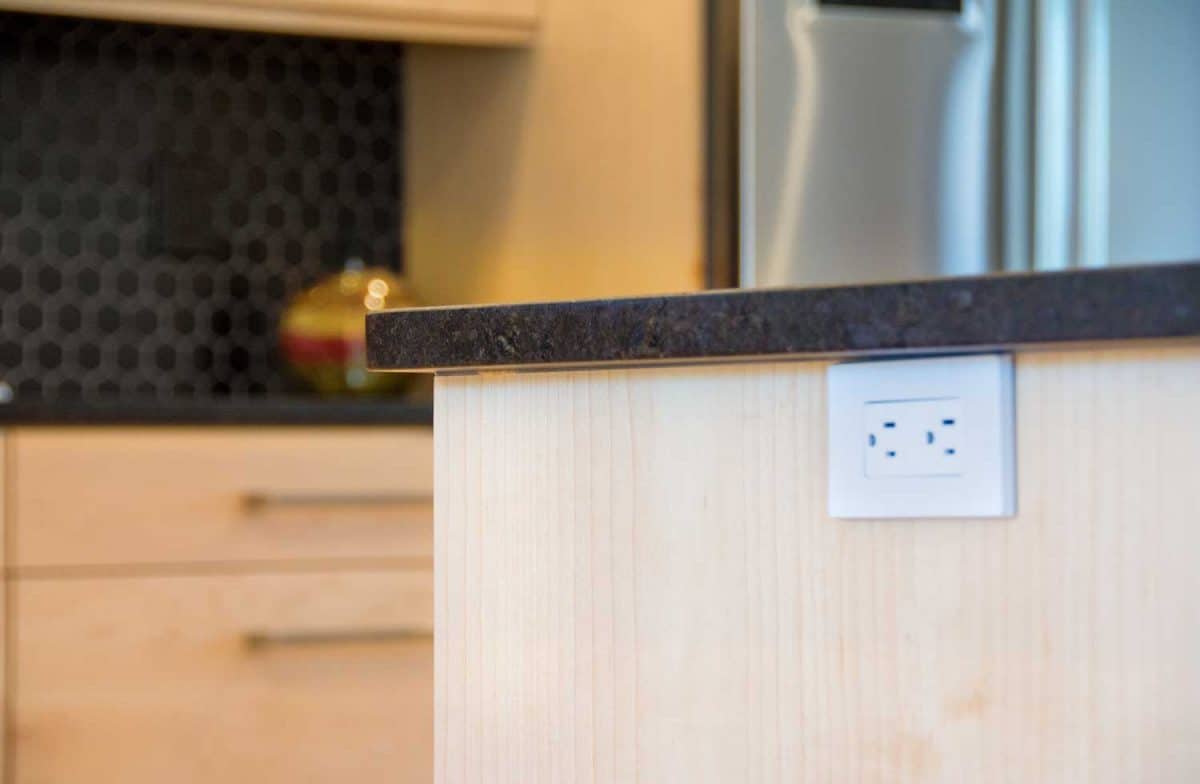 Close-up of a kitchen island and and outlet on the side