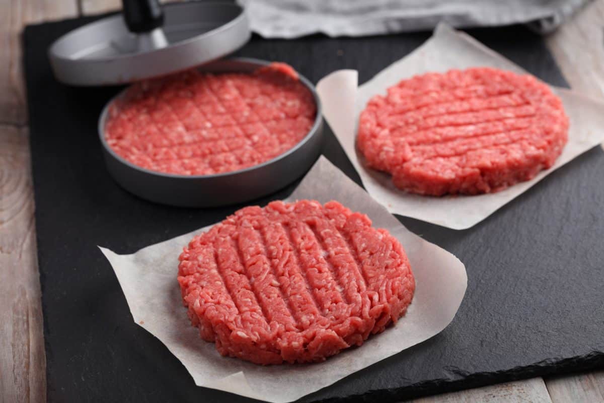 Cooking beef hamburgers from minced meat with meat press