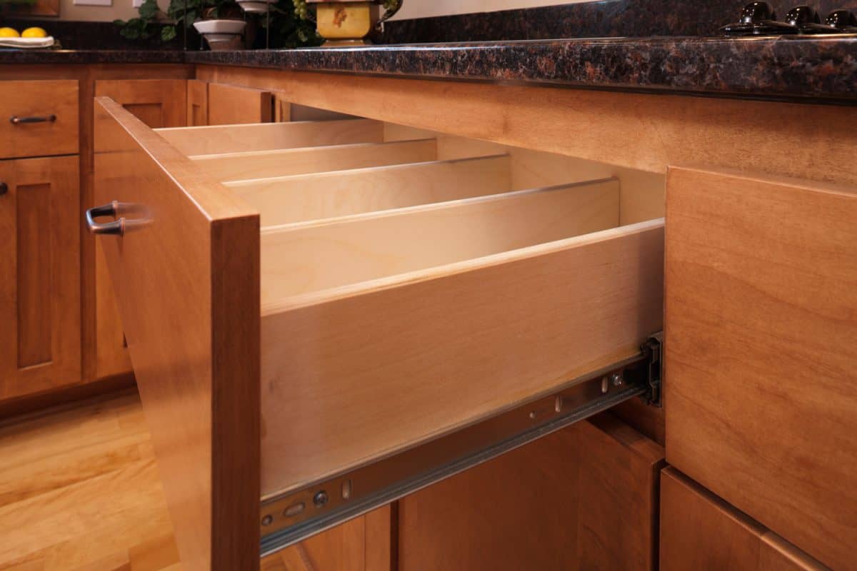 Custom kitchen cabinetry with a maple drawer pulled out for demonstration