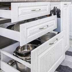 Drawers open in modern white wooden kitchen, Kitchen Drawers Open By Themselves - What To Do?