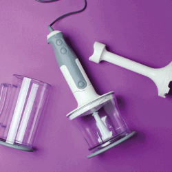 Electric hand blender with nozzles on a purple background. Can An Immersion Blender Grind Coffee Beans