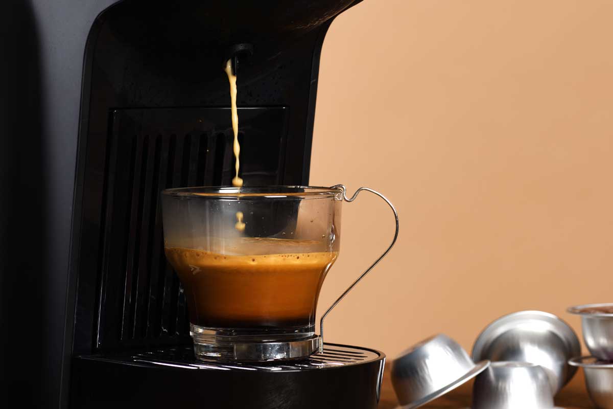 Espresso machine making coffee in glass cup, How To Drain The Water From Your Keurig