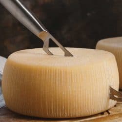 Fresh homemade cheese on a wooden board with a knife, How Do You Keep Cheese From Sticking To The Knife?