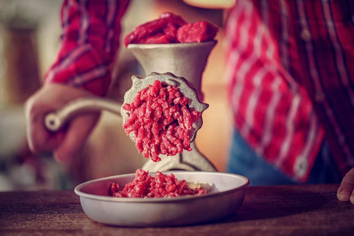 Fresh minced beef and pork meat in a mincer.