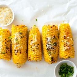 Grilled corn cobs grated with cheese and chives, 5 Ways To Reheat Corn On The Cob