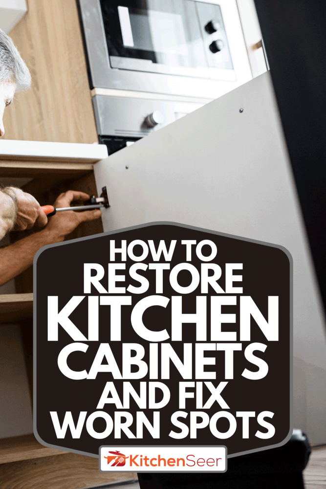 A repairman in uniform working, fixing kitchen cabinet using screwdriver, How To Restore Kitchen Cabinets And Fix Worn Spots