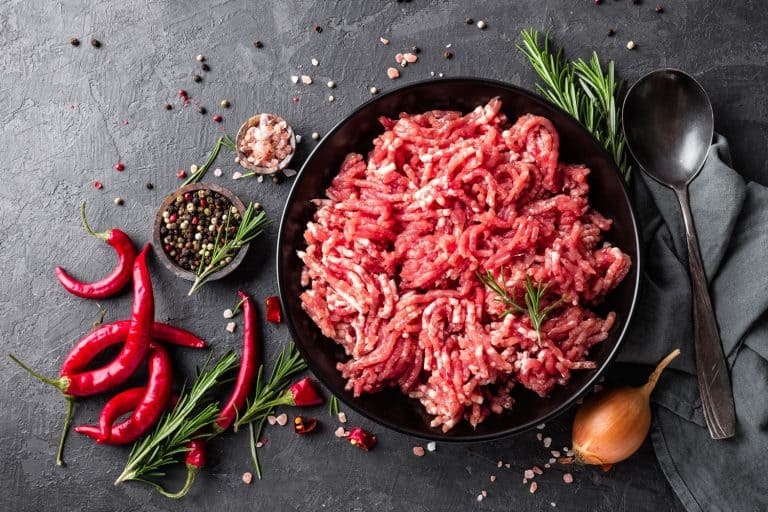 Mince. Ground meat with ingredients for cooking on black background, Can You Refreeze A Hamburger?