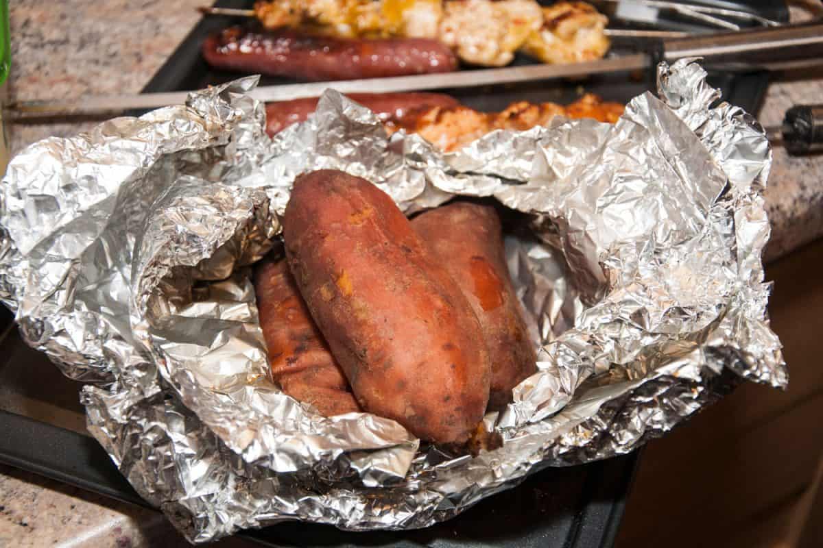 Oven baked sweet potatoes wrapped in tin foil