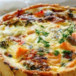Quiche with broccoli, salmon and fresh thyme on a white plate, How Long Do You Let Quiche Rest?