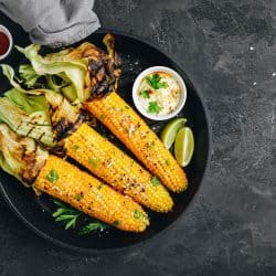 Roasted or grilled sweet corn cobs with garlic butter and lime, Is It Better To Grill Corn With Or Without The Husk?