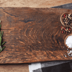 Salt, pepper and rosemary branch on top of wooden chopping board. Does A Cutting Board Need To Be Oiled
