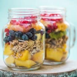 Two jars of assorted fruits on a wooden chopping board, Can You Keep Fruit In The Pantry? [How To Properly Do So]