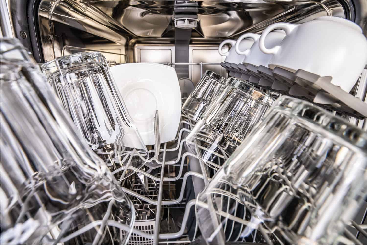 Upper cell of dishwasher with clean shiny cups and glasses