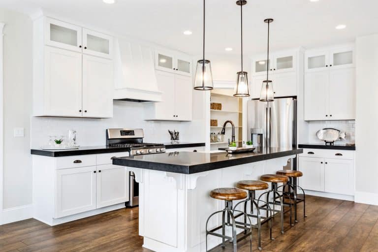 White gourmet kitchen with black countertops, Is A Kitchen Island Fixed To The Floor?