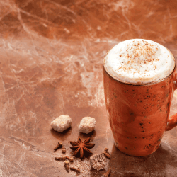 cappuccino coffee and spices. dark marble background