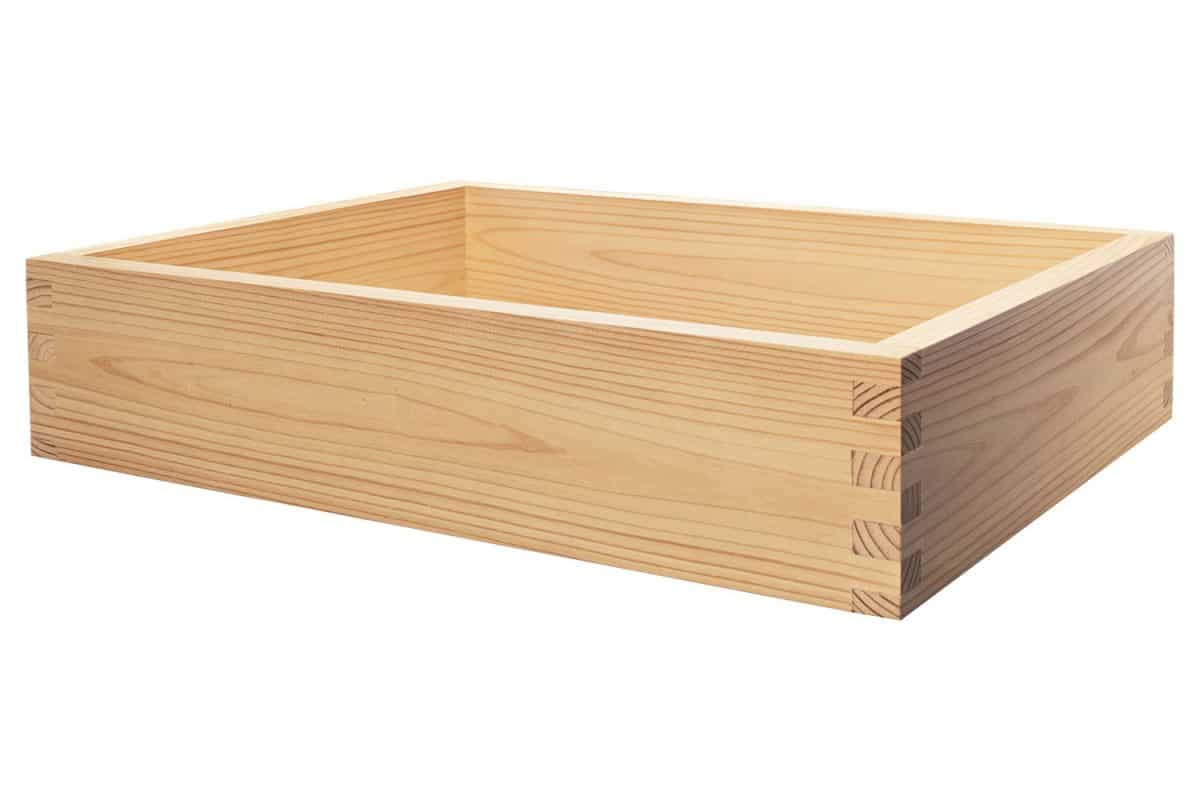 A dovetail wood joint kitchen drawer on a white background