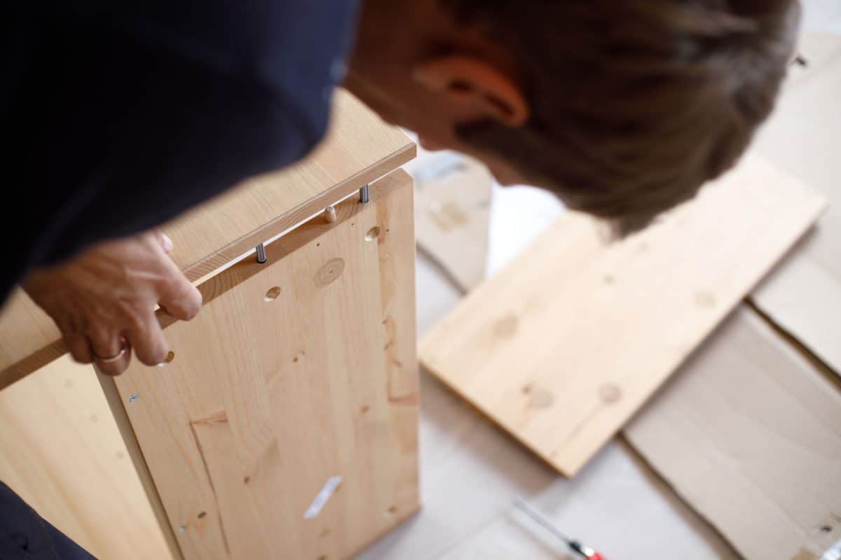 A man making kitchen drawers using dowels to assemble it