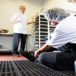 A man trips on a mat in a commercial kitchen, 5 Best Anti-Fatigue Kitchen Floor Mats To Check Out