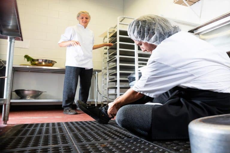 A man trips on a mat in a commercial kitchen, 5 Best Anti-Fatigue Kitchen Floor Mats To Check Out