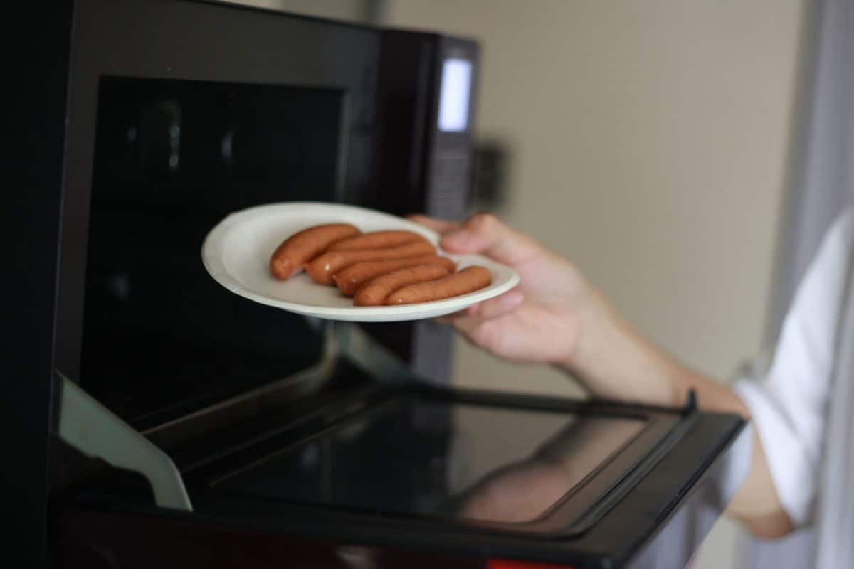 A man who arranges wieners on a paper plate and tries to heat them in the microwave, Can Paper Plates Go In The Microwave?