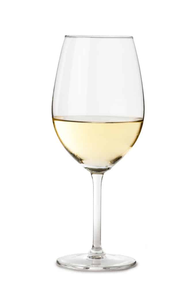 A standard wine glass with sparkling champagne on a white background