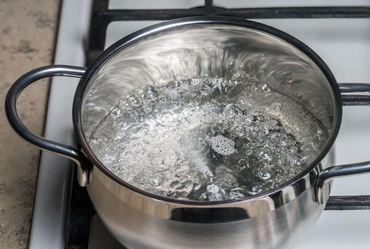 Boiling water in a stainless saucepan on a gas stove