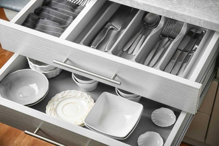 Ceramic dishware and cutlery in kitchen drawers, How To Remove Kitchen Drawers [A Complete Guide]