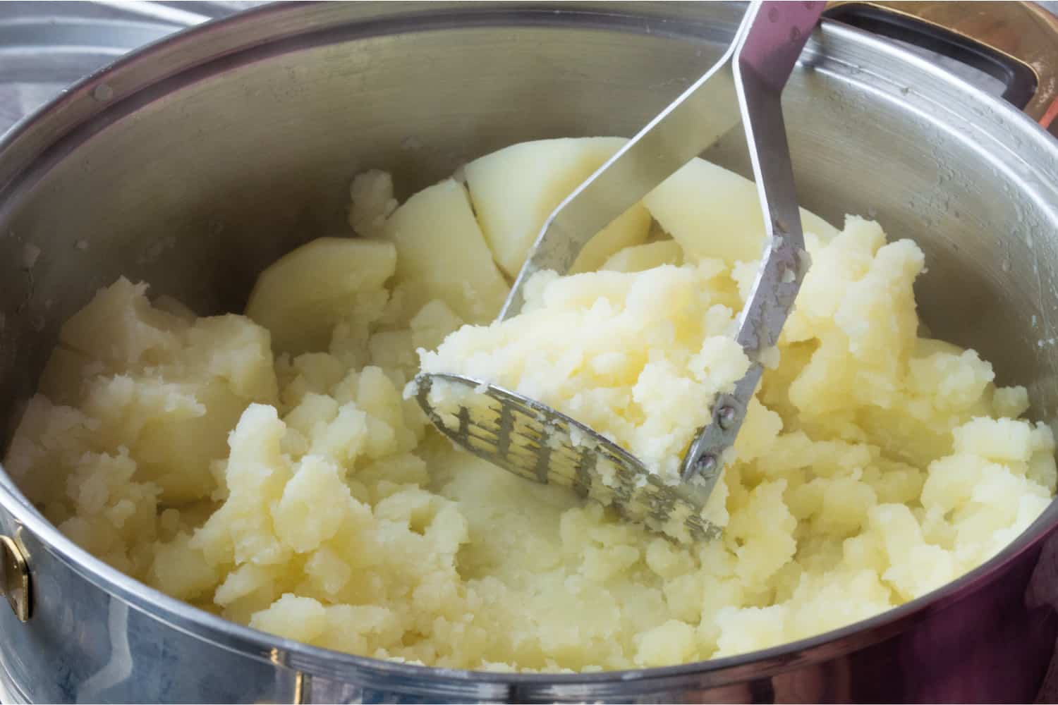 Close up image of a silver pan of mashed potato