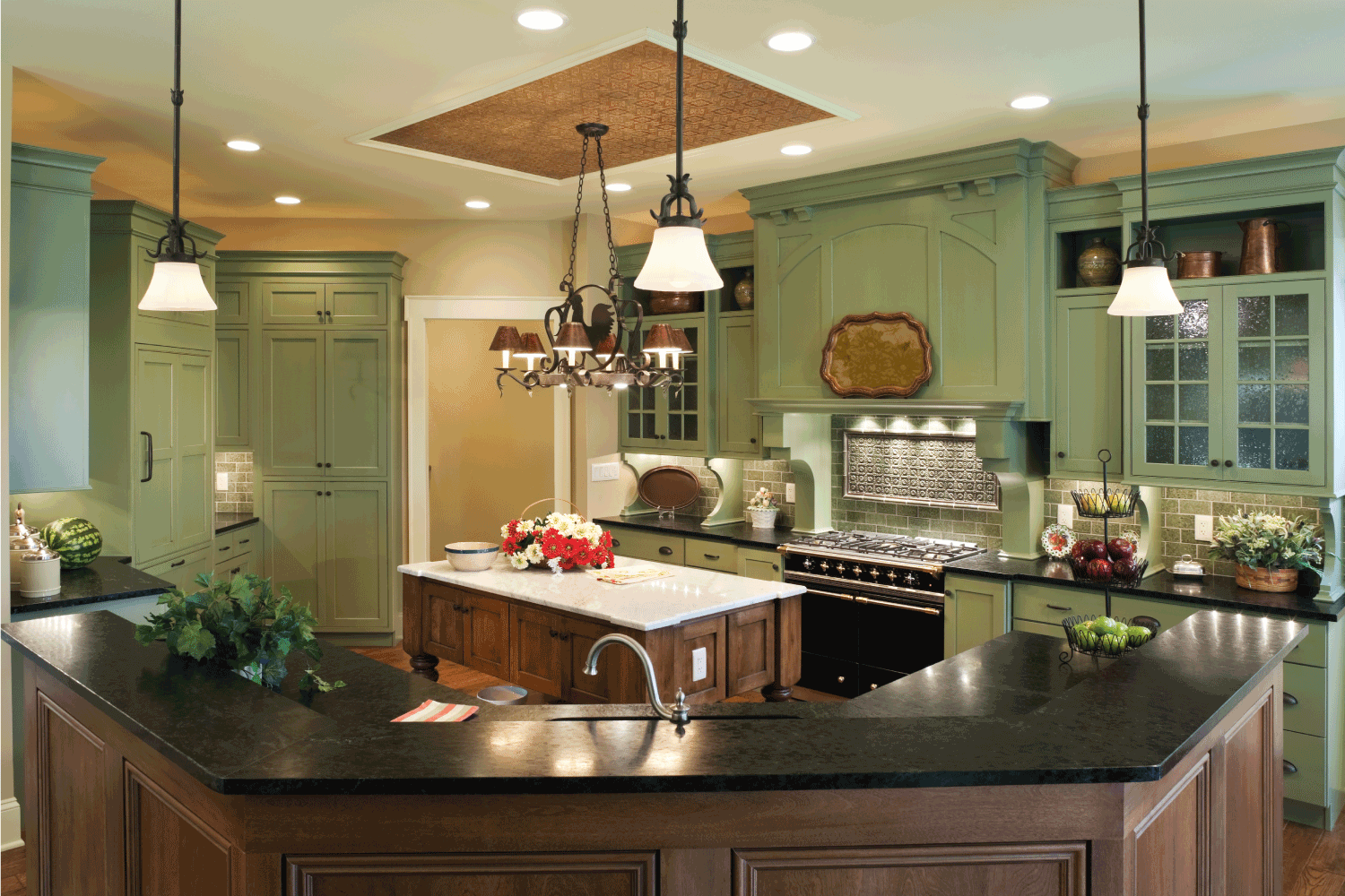 Country style gourmet kitchen in a residential home with painted custom cabinets, marble topped center island, soapstone counter tops and tin ceiling inlay.