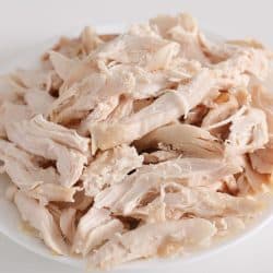 Fresh shredded chicken on a white plate, Can You Shred Chicken In A Food Processor?