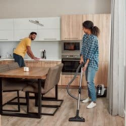 Happy multicultural couple in casual clothes cleaning their modern kitchen together, How To Make A Kitchen Floor Tile Look New