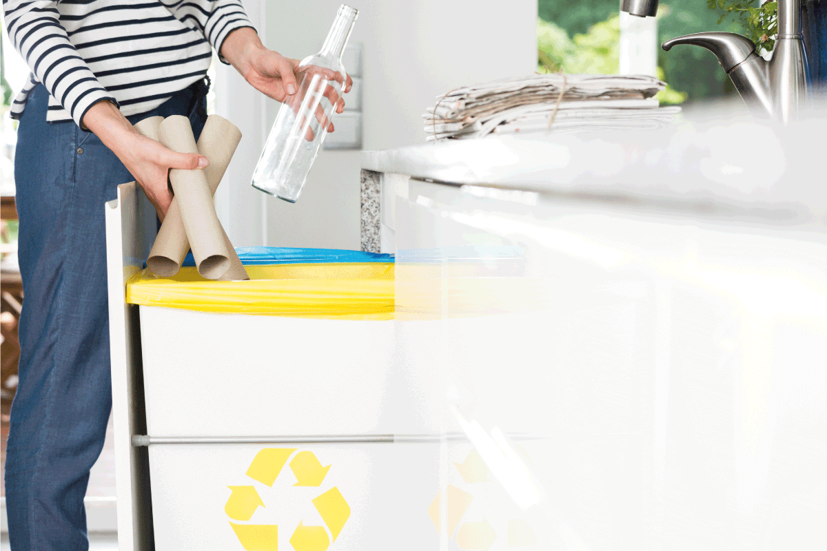 Housewife throwing paper into yellow bin