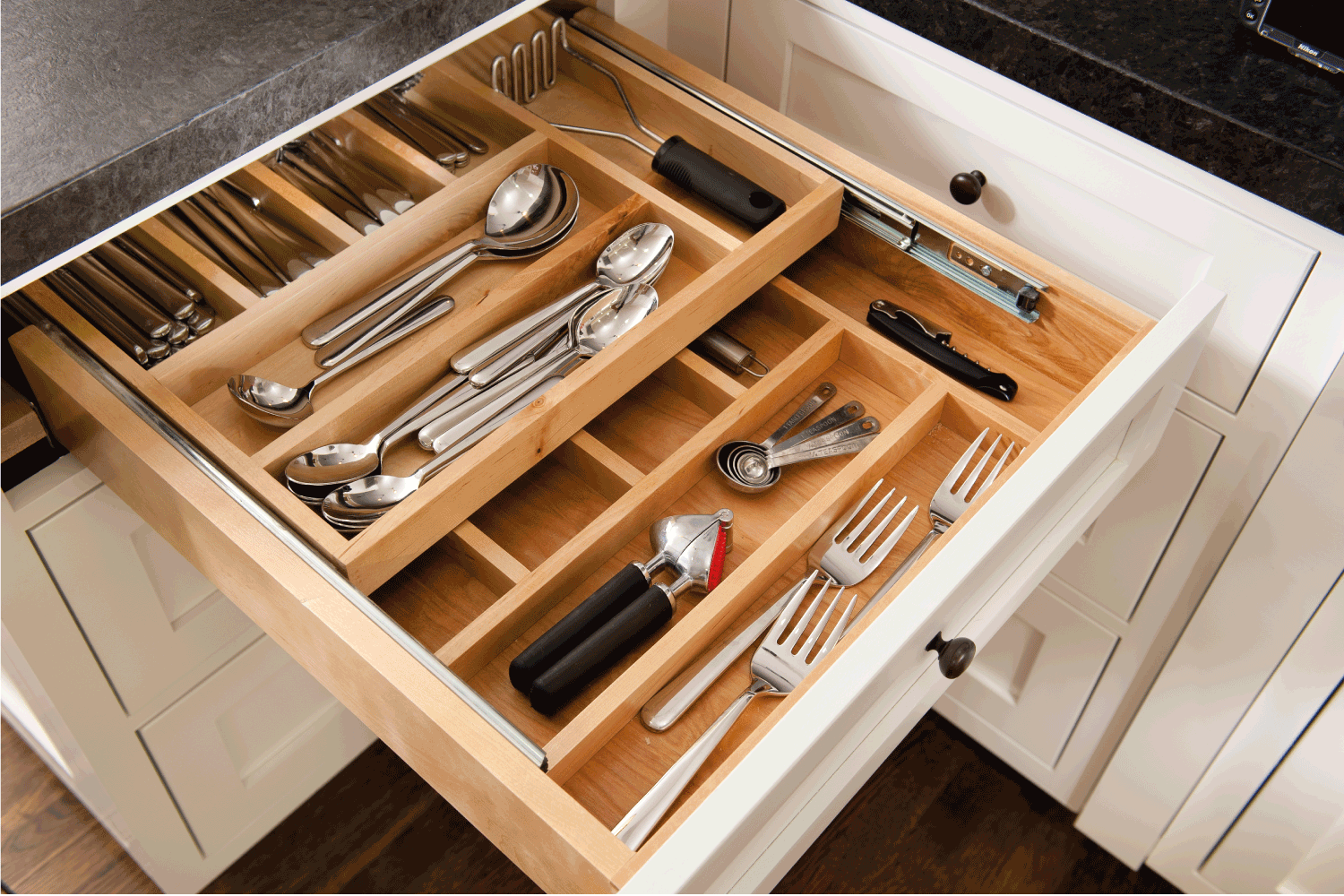 Kitchen silverware drawer with compartments.