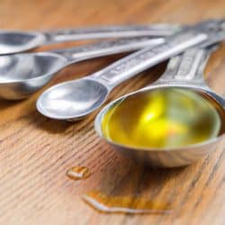 Olive oil in a measuring tablespoon, Spilled Cooking Oil On Kitchen Floor - How To Clean It Up