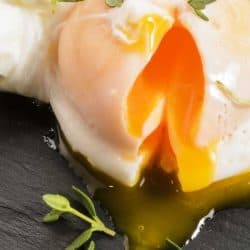 Open organic poached egg with thyme on slate, How To Poach An Egg With A Ladle - All You Need To Know!