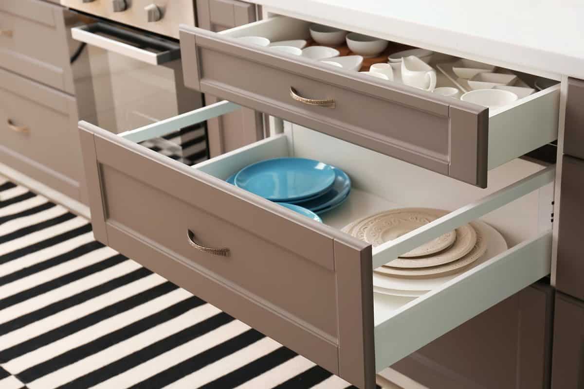 Set of ceramic tableware in kitchen drawers