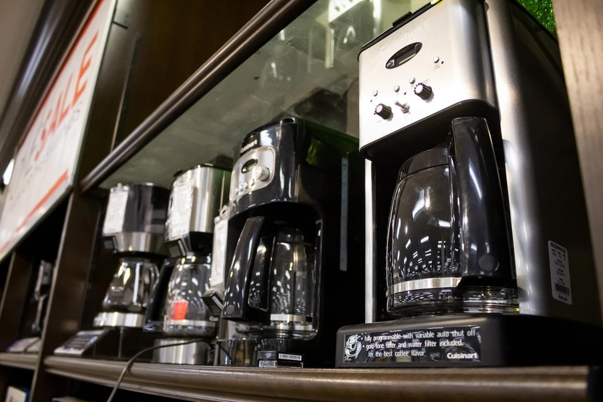 Several Cuisinart coffee maker machines on display at a local department store