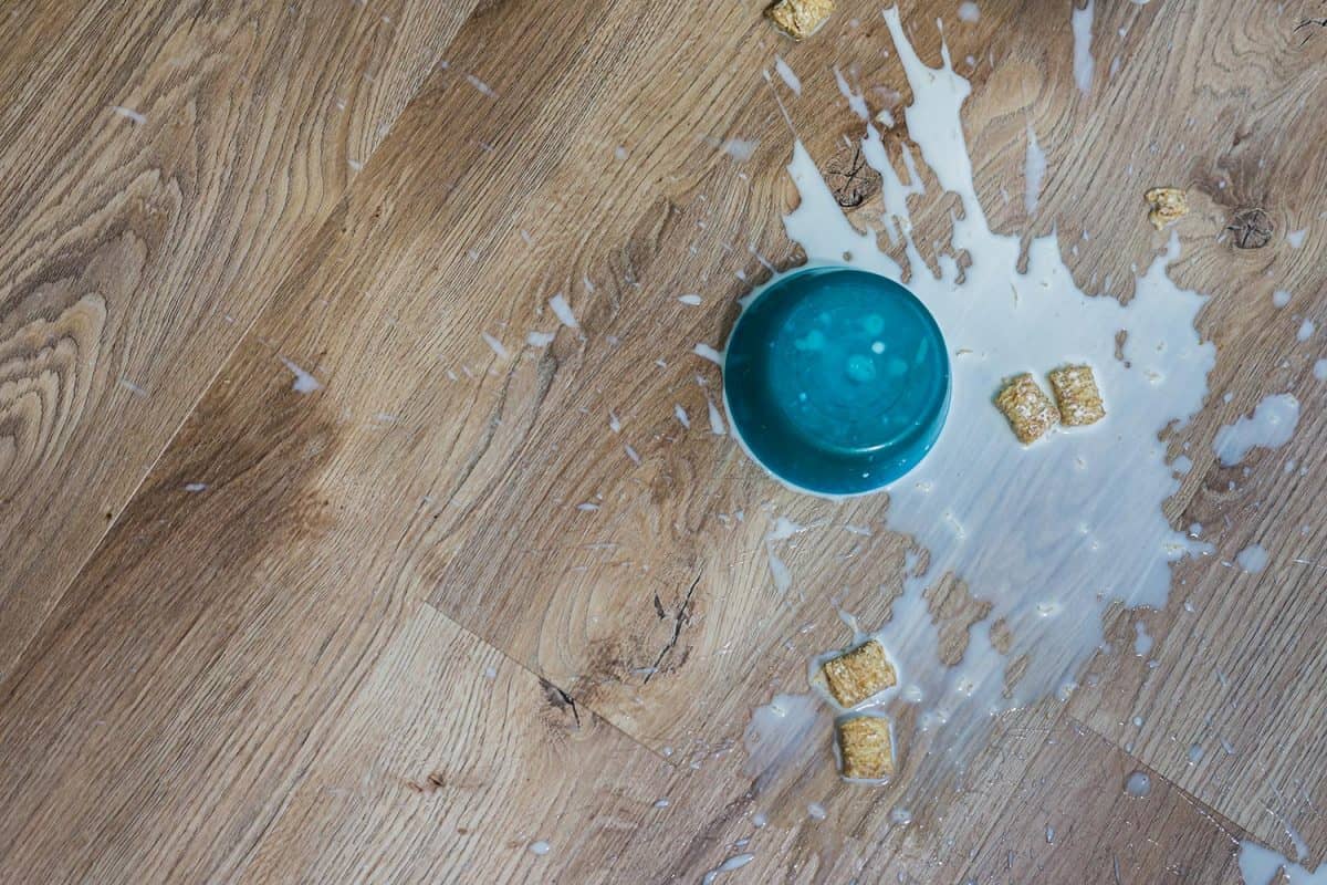 Soggy cereal and milk spilled onto waterproof luxury vinyl hardwood floor
