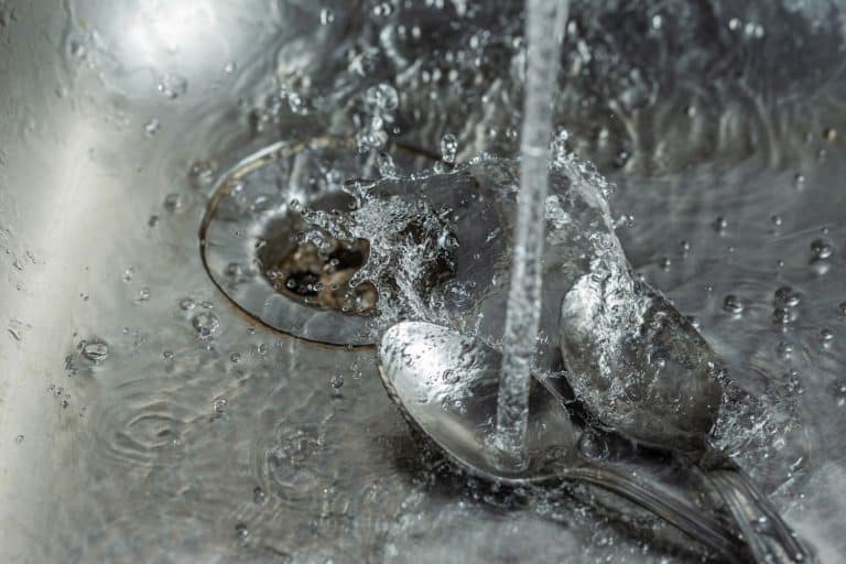 Stream of water falling into a teaspoon and splashing down the sink and garbage disposal, Can A Spoon Break A Garbage Disposal?