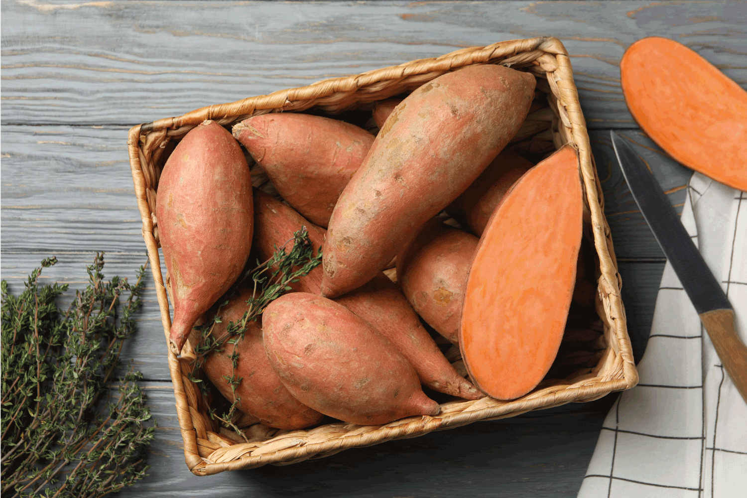 Sweet potato in basket on wooden background