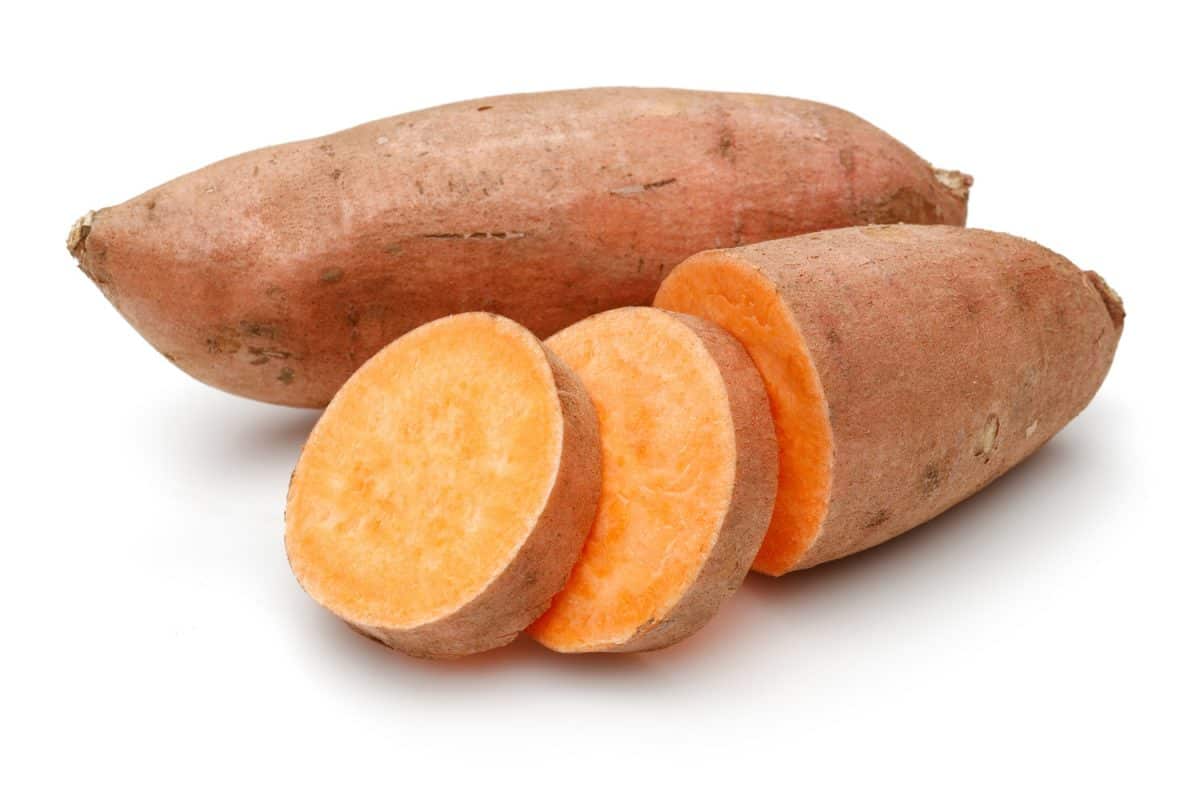 Sweet potato with slices isolated on white background