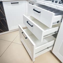 Three white kitchen drawers inside a white themed kitchen, Can Kitchen Drawers Be Converted To Soft Close?