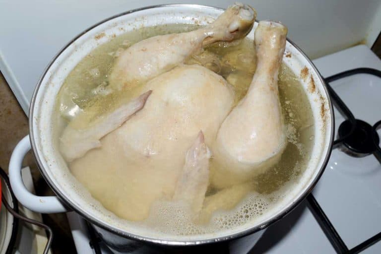 Whole chicken boiled in a saucepan on a gas stove, Should You Boil Chicken Before Frying?