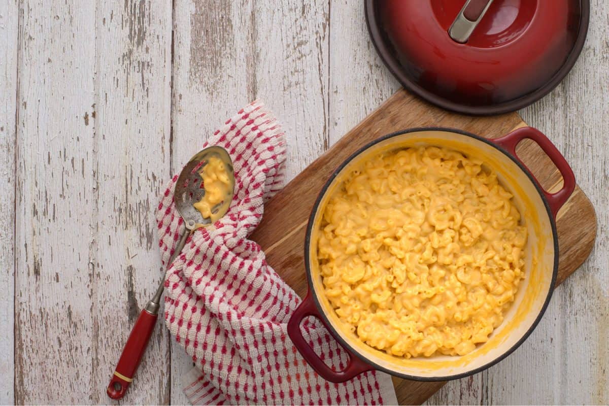 A casserole of mac and cheese on a serving board