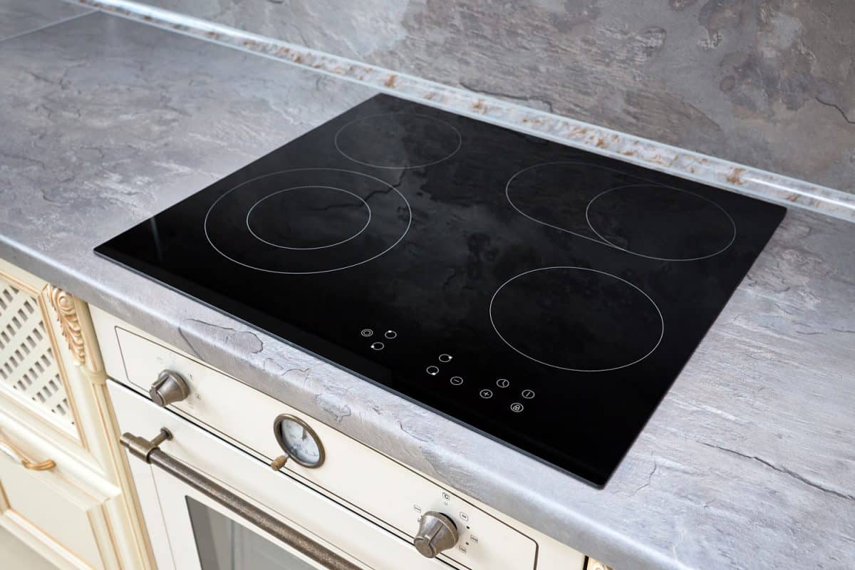An induction cooker installed in the marble countertop of the kitchen 